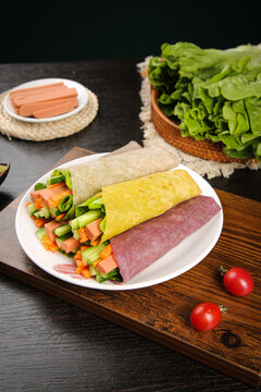 Healthy Breakfast Wraps with Fresh Vegetables and Greens on Rustic Wooden Table