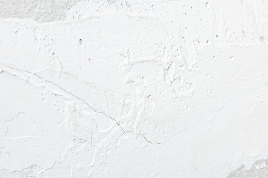 White plaster texture on concrete wall background, rough cement surface with filler.