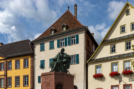 Close view of Johannes Kepler monument against colourful historic buildings in Weil der Stadt, Germany.
