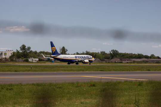 Ryan Air commercial passenger airplane taxiing on the asphalt tarmac and takeoff at an airport runway in Romania