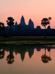 Fototapeta premium Siem Reap, Cambodia - February 20, 2020: Pink Dawn Sky Behind the Silhouette of Angkor Wat