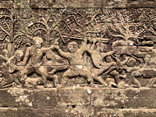 Fototapeta premium Siem Reap, Cambodia - February 20, 2020: Carved Wrestling Scene on the Bayon's Outer Wall