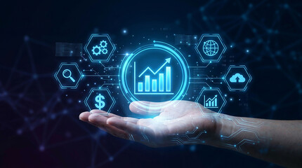 Fototapeta premium Digital Business Growth Concept: A human hand holds a glowing digital interface displaying a growth chart, surrounded by abstract technological icons.