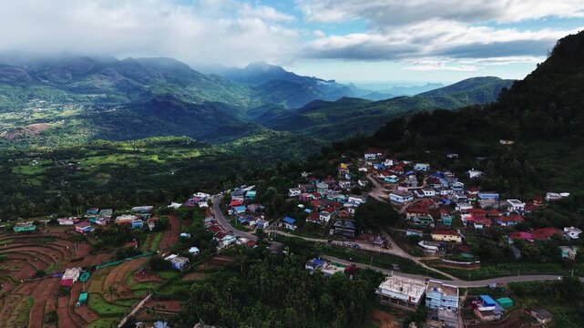 Aerial view of a hill town surrounded by green mountains in Kerala, India