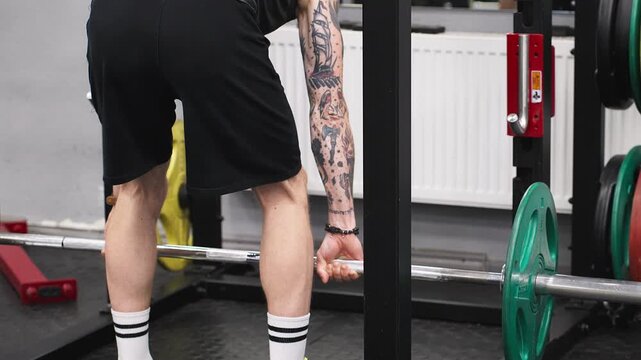 A man is performing a barbell deadlift