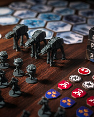 Fototapeta premium Imperial army miniatures assembled on a Battle of Hoth tabletop battlefield featuring AT AT walkers, scout droids and infantry captured with dramatic lighting in a cinematic perspective