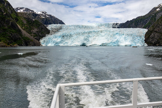 Cruise ship wake trailing towards Holgate Glacier under an overcast sky in Kenai Fjords National Park Alaska USA
