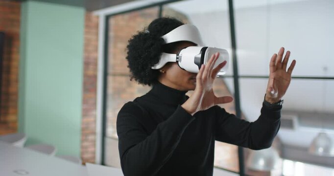 African American man fitting white VR headset raising hands manipulating virtual UI in meeting room