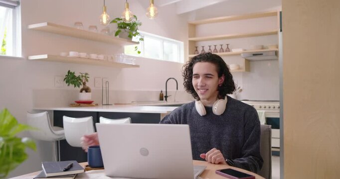 African American man gesturing on laptop call, then reaching for notebook and taking notes