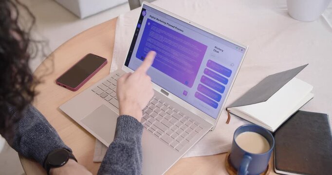 African American man spotting purple chat panel, tapping, dragging, typing reply on laptop at table