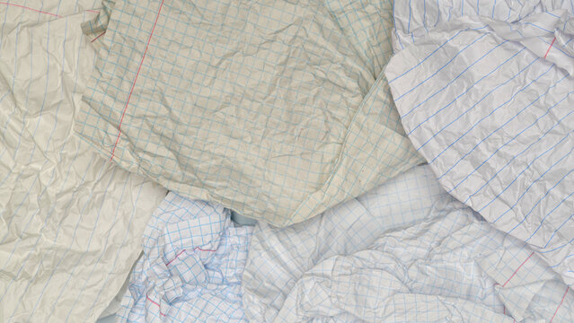 heavily creased notebook sheets in grid and line