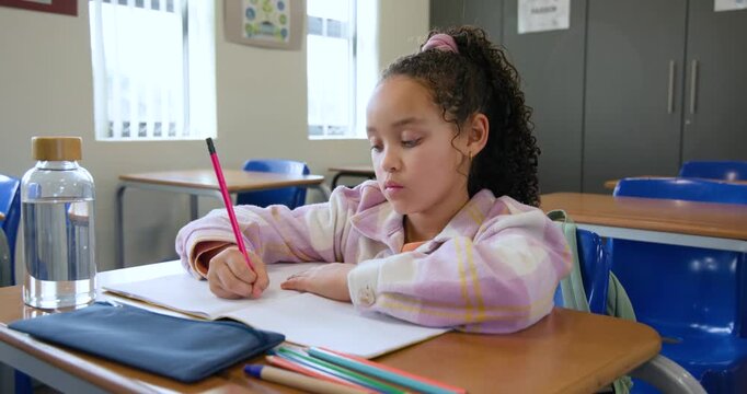 African American teen plaid-hoodie starting work red-pencil writing resting rubbing temples at desk