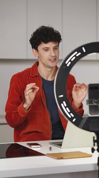 Friendly male blogger recording video for social network on phone, influencer
