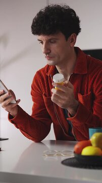 Focused young man researching information about pills on phone, mobile app
