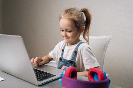 Studio portrait of young girl engaging in online education, actively participating in virtual classes and distance learning from home, utilizing modern technology for studies.