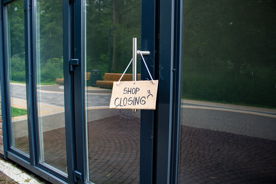 SHOP CLOSING sign on private shop window. Small local retail business closes because of financial and economic crisis. Entrepreneurs faces market changes