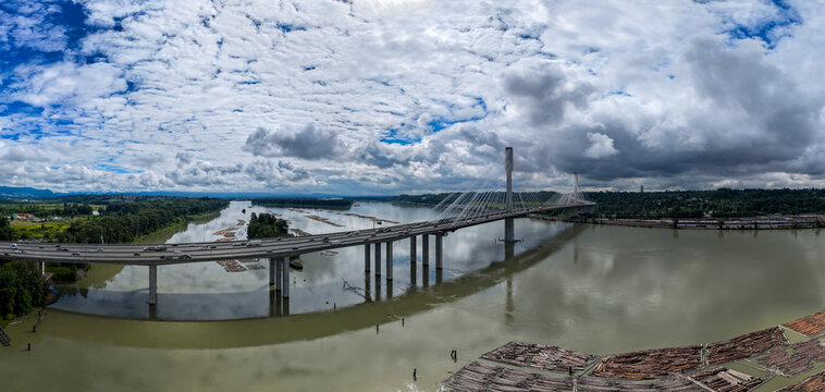 Cable-Stayed Bridge Over Fraser River With Log Booms and Traffic Near Coquitlam, Vancouver, British Columbia, Canada