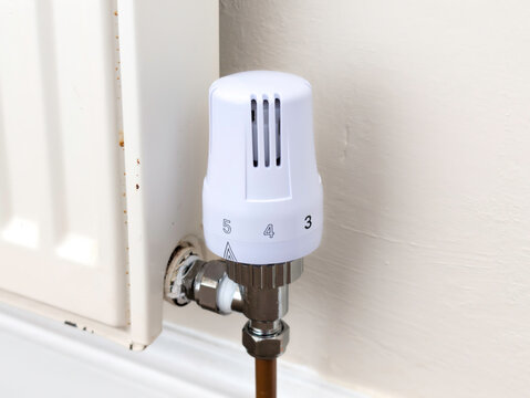 Modern White Thermostatic Radiator Valve (TRV) on Domestic Home Heating Radiator