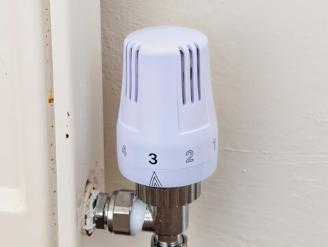 Modern White Thermostatic Radiator Valve (TRV) on Domestic Home Heating Radiator