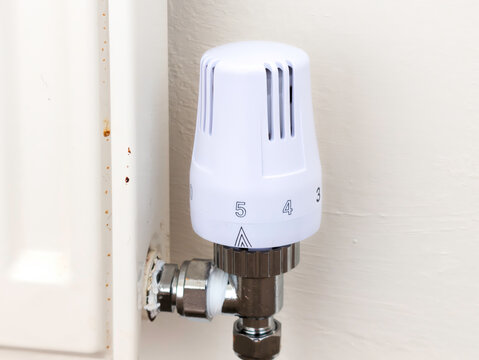 Modern White Thermostatic Radiator Valve (TRV) on Domestic Home Heating Radiator