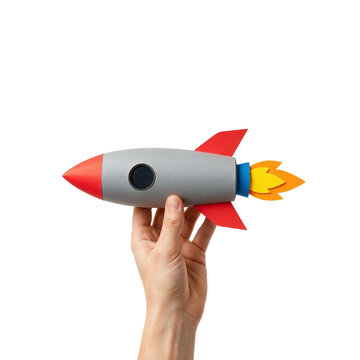 Hand holding a handmade paper toy rocket with fire as cut out PNG
