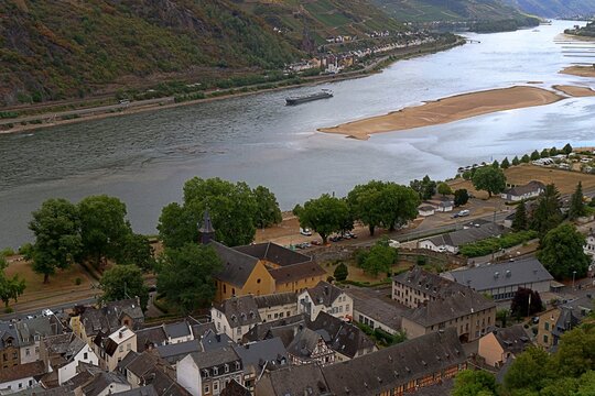 Bacharach, Rhineland Palatinate, Germany &ndash; Elevated view over Bacharach Rhine River vineyards and cargo ship in Upper Middle Rhine Valley