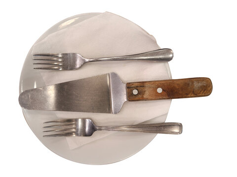 Empty white plate with silver forks and metal cake server on napkins isolated on transparent background top view professional cutlery setting for dining or dessert service display.