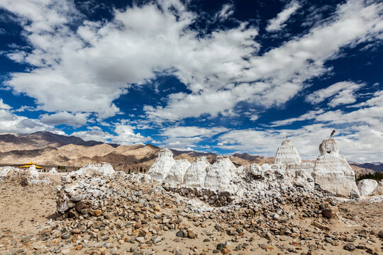 Scene featuring whitewashed chortens (Tibetan Buddhist stupas). Ladakh, Jammu and Kashmir, India