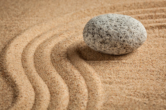 Japanese Zen stone garden - relaxation, meditation, simplicity alongside balance concept - pebbles and raked sand tranquil calm scene