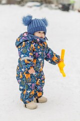 Toddler holding snowball maker during winter walk © Olha Tsiplyar