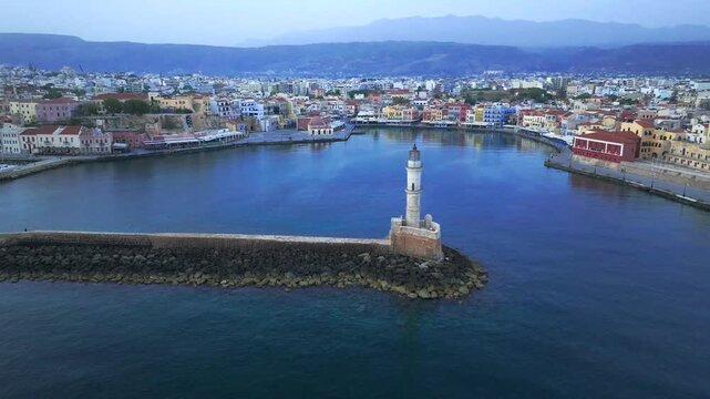 View of Chania with the amazing lighthouse, mosque, venetian shipyards, Crete, Greece.Waves crashing on lighthouse, Beautiful Greece and best scenic places - panorama