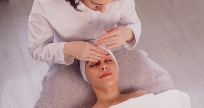 Cosmetologist spa beautician gentle massage, doing facial female face skin care, beauty treatments, perfect healthy, wellness beauty salon dermatologists professional service, rubbing and kneading 
