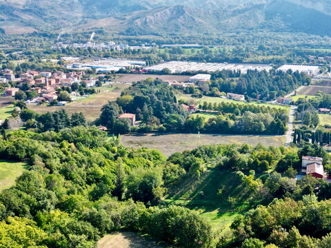 Aerial photo of dense green forest and village in Italy for environmental background