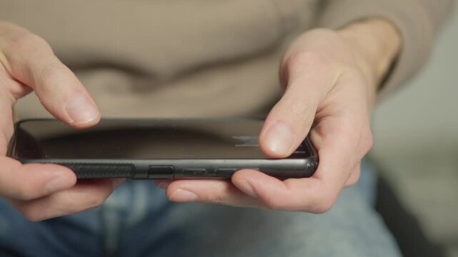 A detailed view shows fingers tapping on a smartphone screen, highlighting everyday digital interaction. The image captures the essence of contemporary connectivity and technology use