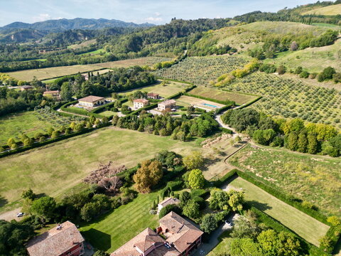 Aerial view of luxury villa estate and olive grove in Italy for travel marketing