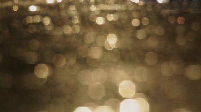 Reflection of sunset in water for natural background with glow and glitter