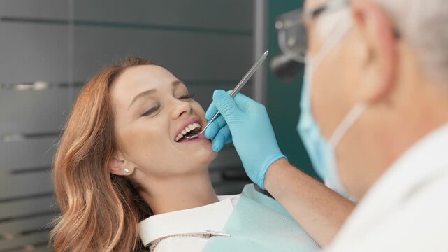 Female patient enjoys comfortable dental care experience during regular checkup with skilled dentist. Preventive dentistry and oral health maintenance are essential for a confident smile
