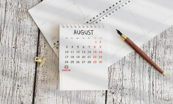 August 31 Deadline Marked on Calendar with Planner and Fountain Pen &ndash; Time Management Concept