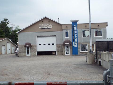 Gatineau, Quebec, Canada &ndash; June 11, 2026: A commercial building for "Les &Eacute;quipements EDG" and "Gauvreau Terre de Surface" features a garage door and French signage at 930 Chemin Vanier.
