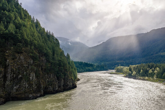 River Valley Through Forested Cliffs With Sunrays and Mist Over Mountains Near Yale, British Columbia