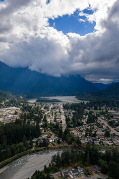 Aerial View of Hope Valley River and Mountains Under Dramatic Cloud Breaks in British Columbia