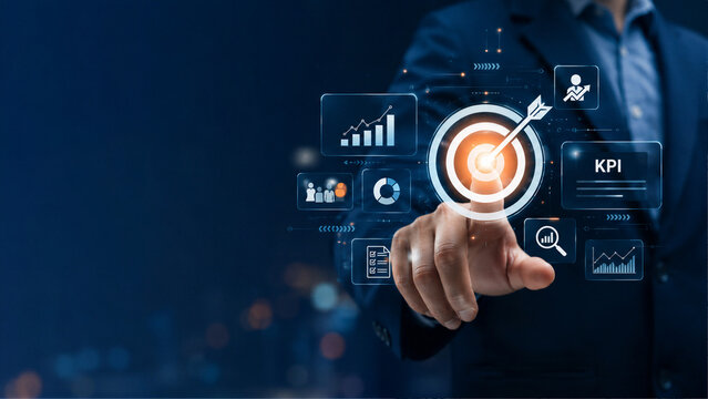 Businessman touching target icon on virtual screen with KPI charts and business analytics dashboard, digital marketing strategy concept