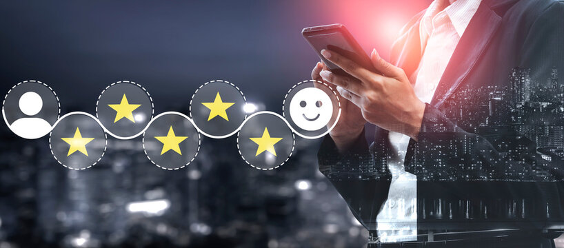 A businessman interacts with his smartphone to rate services using stars and a smiley face, reflecting the importance of feedback and consumer satisfaction in a vibrant urban setting. Ledger