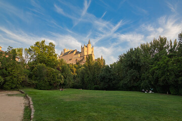 Segovia, spain  07 25 2026 alcázar of segovia castle overlooking a green park © Azulblue