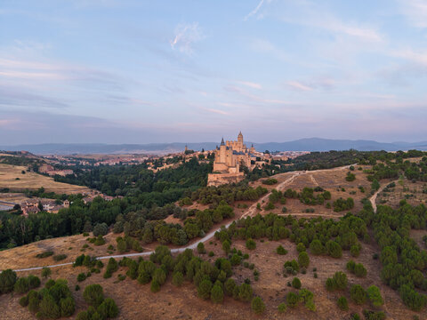 Segovia, spain; 07 25 2026 alc&aacute;zar de segovia castle in rural landscape at sunset