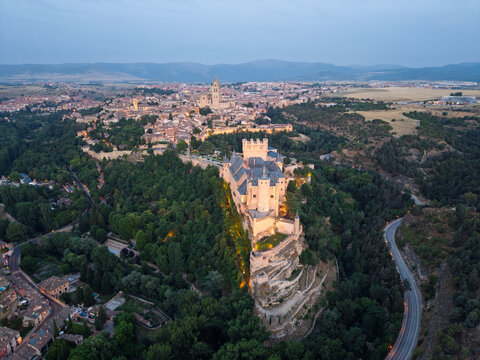 Segovia, spain; 07 25 2026 alc&aacute;zar of segovia castle and old town at dusk