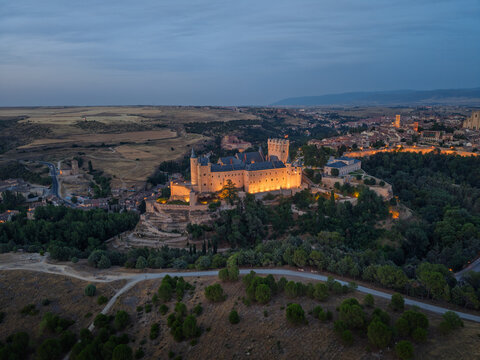 Segovia, spain; 07 25 2026 alc&aacute;zar de segovia castle illuminating cityscape at dusk