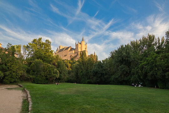 Segovia, spain; 07 25 2026 alc&aacute;zar of segovia castle overlooking a green park