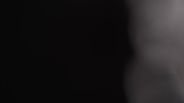 Minimalist black texture with soft gradients and gentle light, evoking a sense of depth and intrigue. Ideal for backgrounds, overlays, or modern visual compositions
