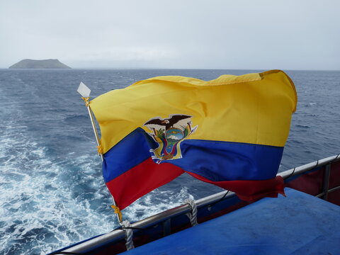 National Flag of Ecuador displayed on back of ship with ocean wake in background